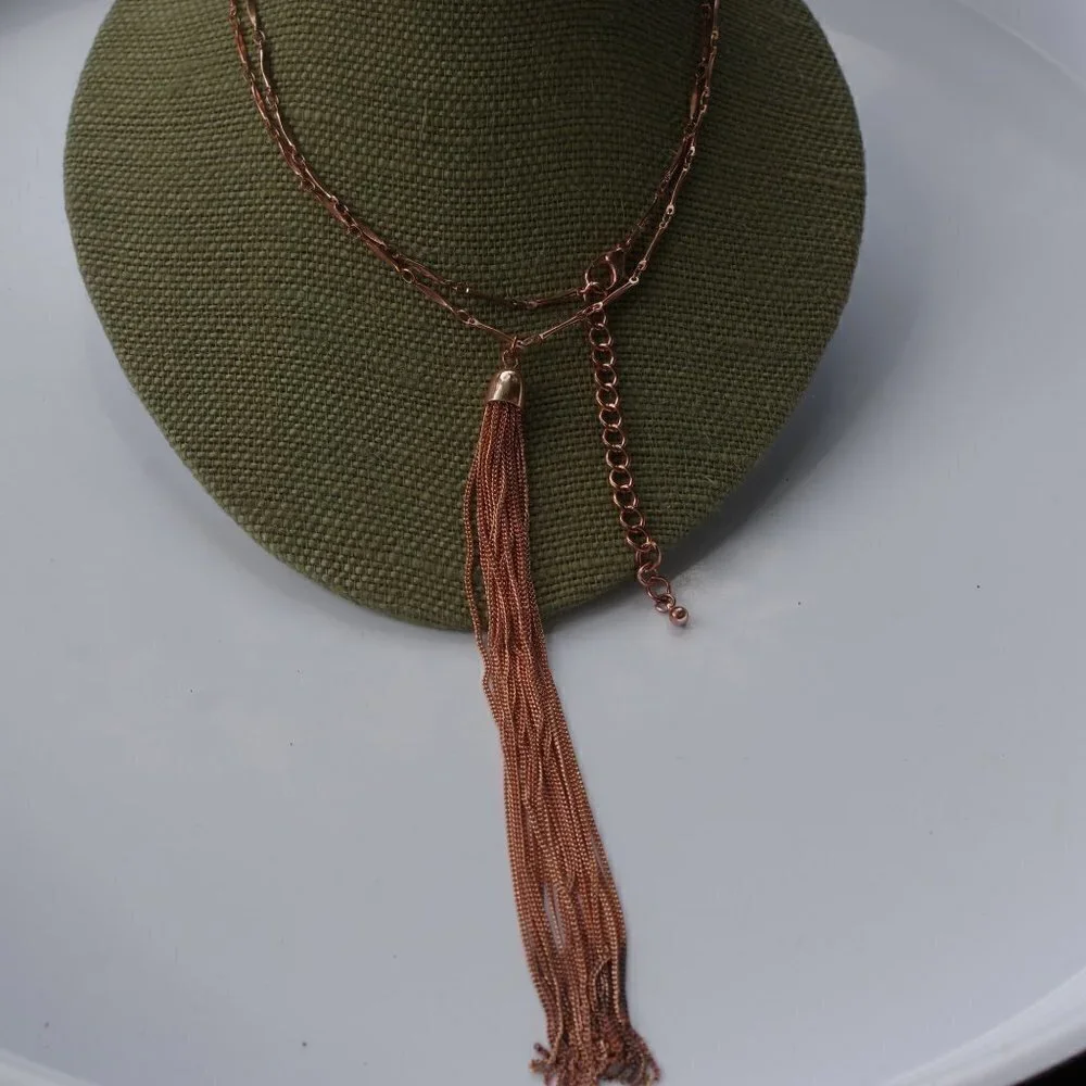 Women`s copper colored long tassel necklace.